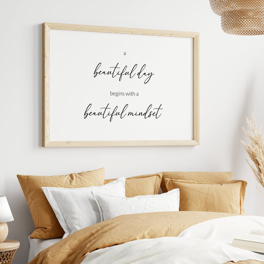 Single landscape typography print. Text reads: a beautiful day begins with a beautiful mindset. All text is in lower case, black on a white background and centre-aligned. The phrases “beautiful day” and “beautiful mindset” are positioned prominently in a modern script font. Remaining text is in a lightweight sans serif font. Styling is elegant and contemporary.