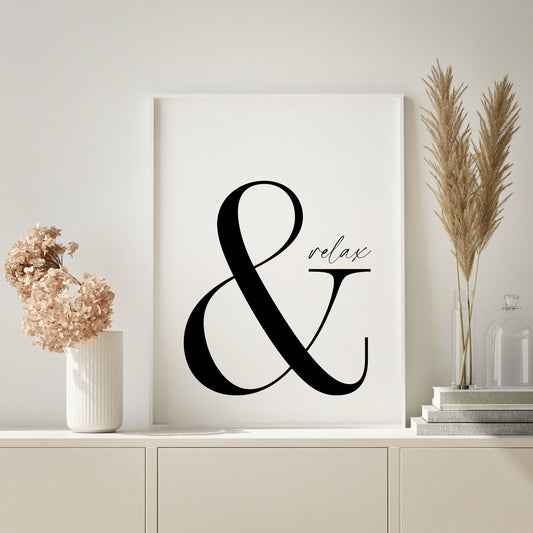Single portrait typography print. Text reads: & relax. Ampersand is in a large serif font, with relax in a much smaller modern script font and positioned on the serif of the &. Text is black on a white background.