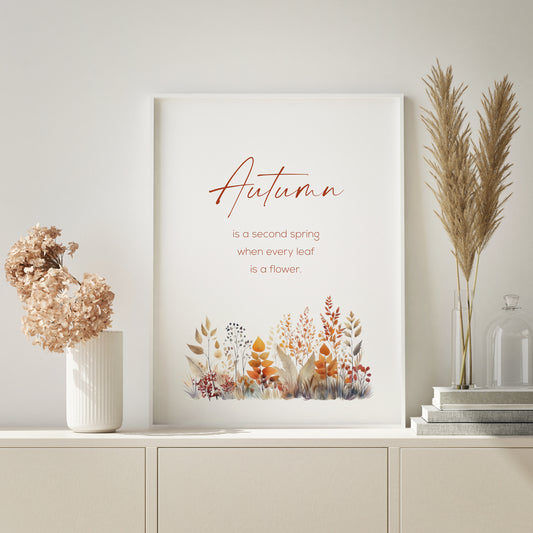 Single portrait print of Albert Camus quote: Autumn is a second spring when every leaf is a flower. The word Autumn is prominent in a modern script font. Other text is in a small, sans serif font. An illustration of autumn foliage is below the text.