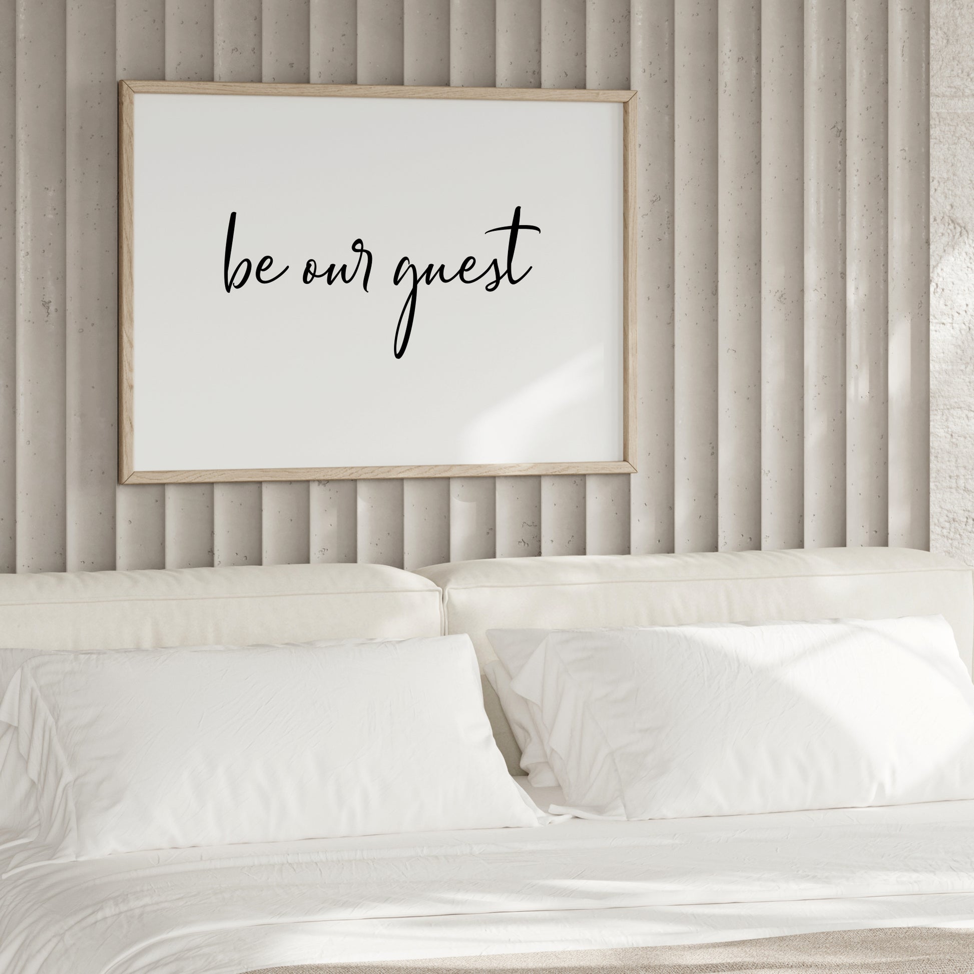 Single landscape typography print. Text reads: be our guest. All text is in a modern and stylish script font, black on a white background.
