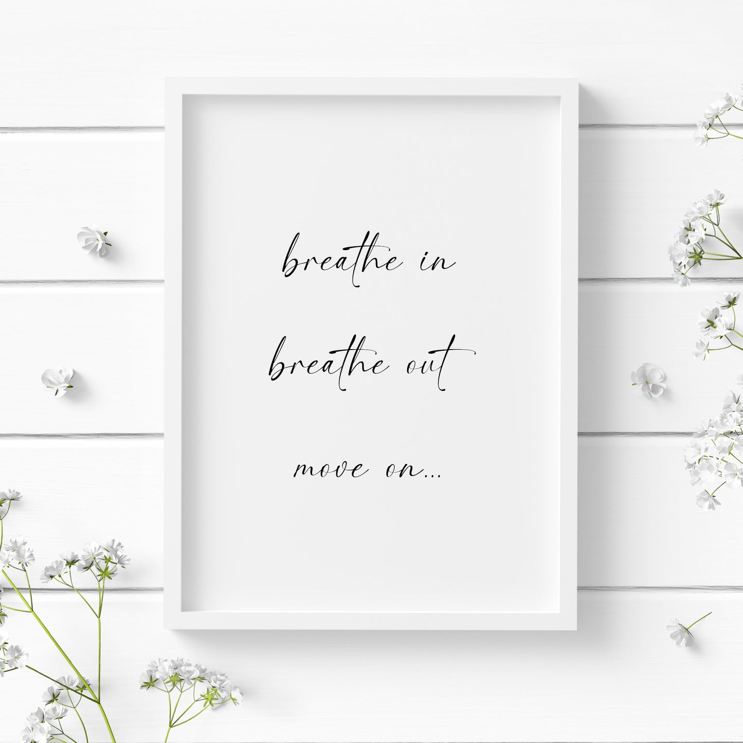 Single portrait typography print. Text reads: Breathe in, breathe out, move on... Text is black on a white background and in a modern lower case script font. Styling is elegant and contemporary.