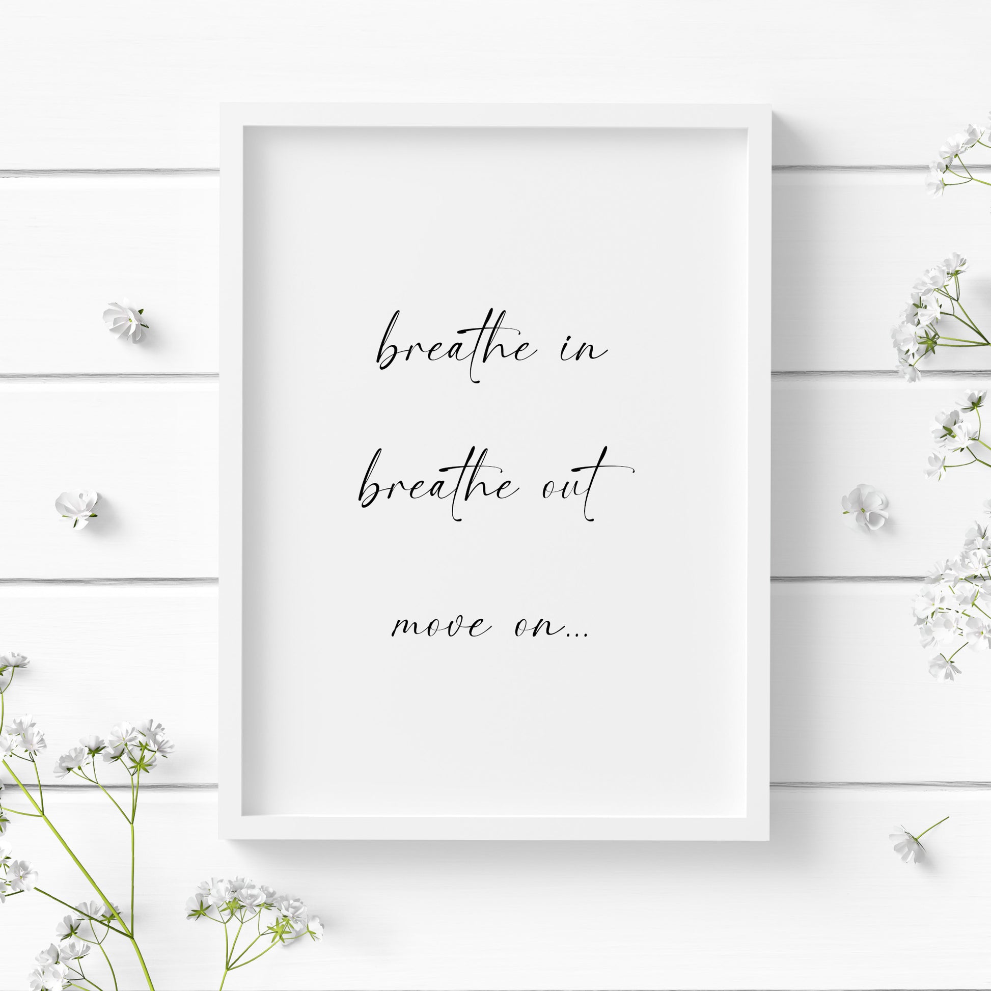 Single portrait typography print. Text reads: Breathe in, breathe out, move on... Text is black on a white background and in a modern lower case script font. Styling is elegant and contemporary.