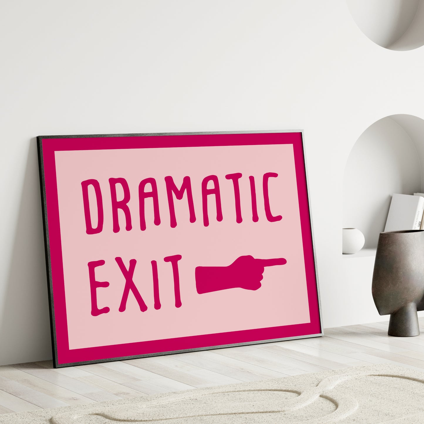 Single landscape print featuring the text "Dramatic exit" next to a hand with a pointed finger. Text is in a playful upper case font, darp pink on a pale pink background. There is also a dark pink border. Styling is retro and fun.