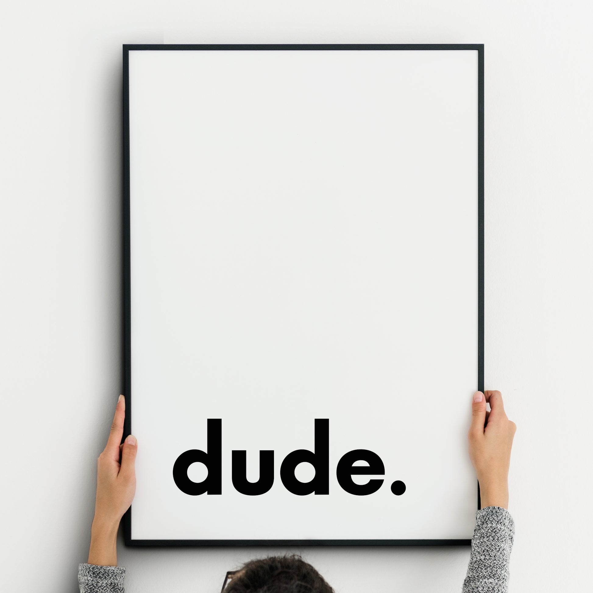 Single portrait typography print. Text reads "dude.", in a bold lower case sans serif font, positioned to the bottom left. Text is black on a white background. Styling is modern and minimalist.