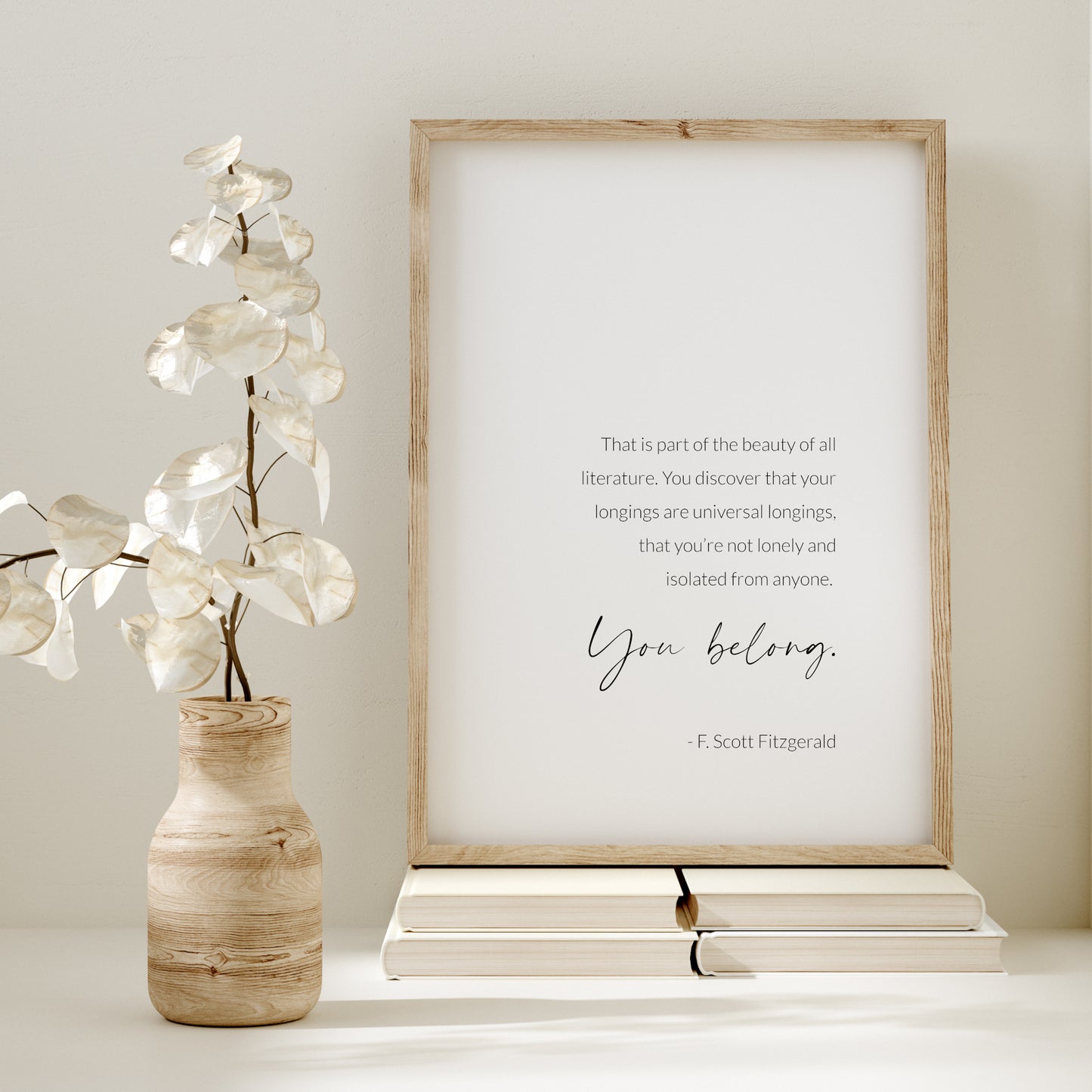 Single portrait typography print featuring an F. Scott Fitzgerald quote. Text is black on a white background, in a crisp sans serif font, other than the words "you belong" which are positioned prominently in a contemporary script font.