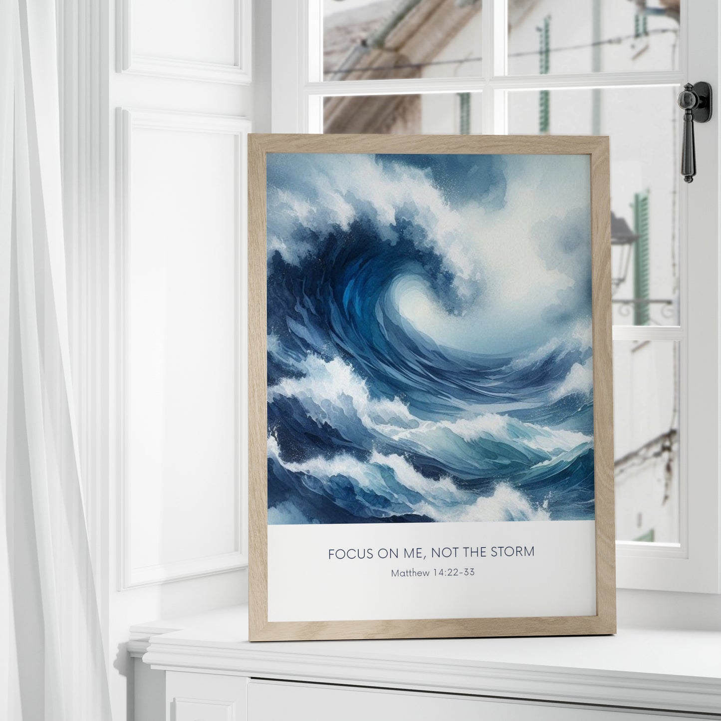 Single portrait illustrated print. Illustration is of a stormy sea showing a large crashing way in moody shades of blue and white. A bible verse is positioned below, reading: Focus on me, not the storm. An attribution to Matthew 14:22-33 is positioned below that again. All text is centre-aligned and in a sans serif font. Text is dark blue on a white background. Styling is contemporary and elegant.