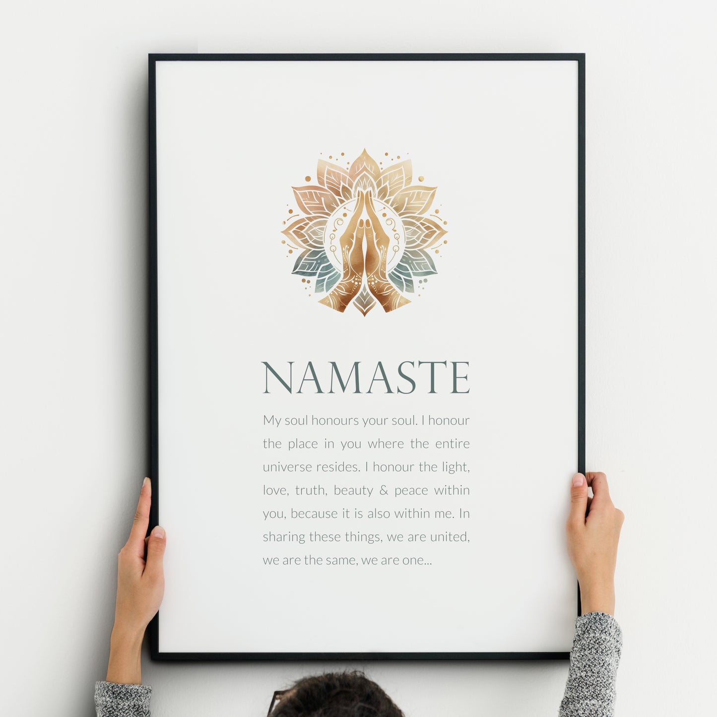 Single portrait print with an illustration of prayer hands at the top and a short reflection on the word namaste below. Colour palette is natural tones and teal / blue-green. Background is white. Styling is modern and elegant.