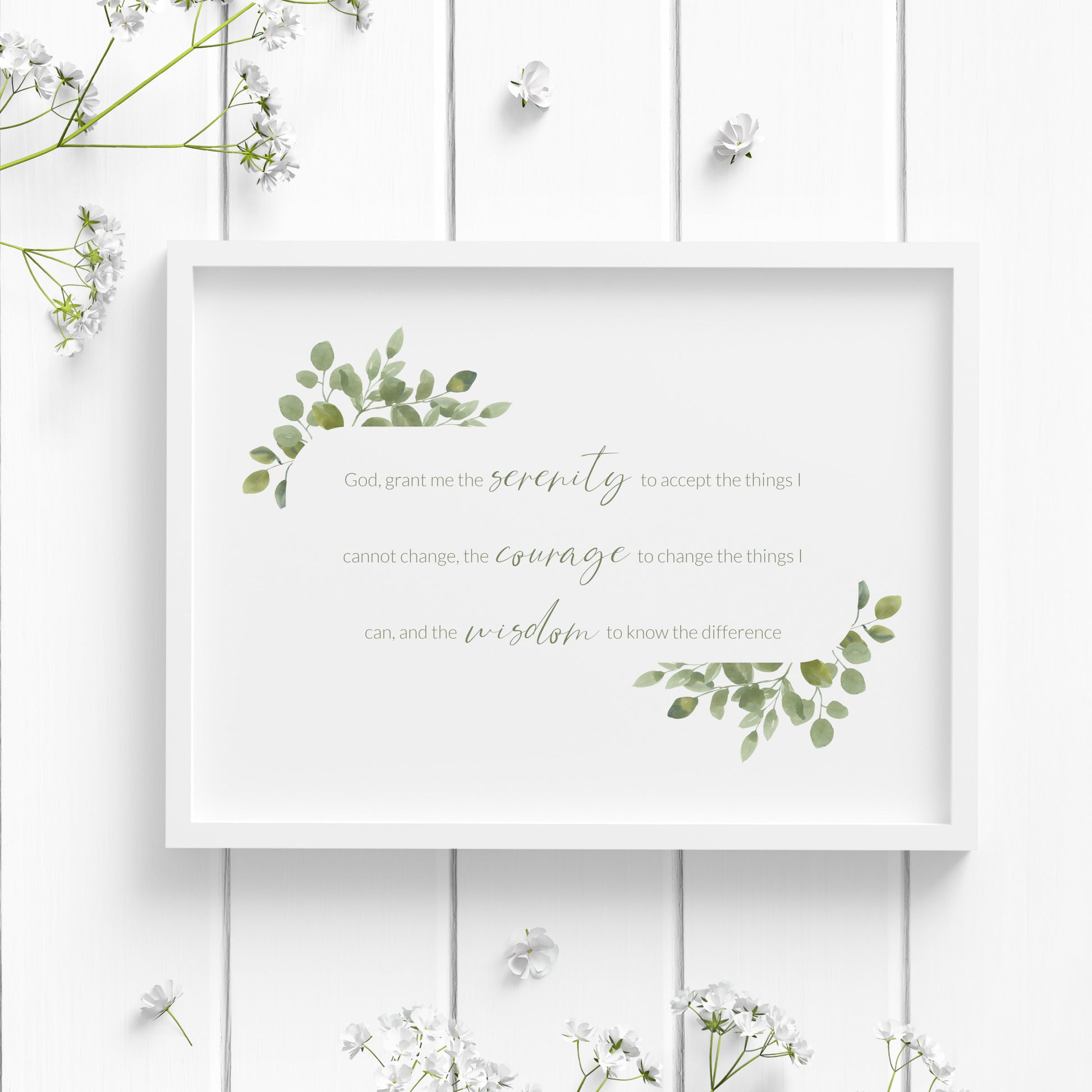 Single landscape print of the Serenity Prayer. Text reads: Grant me the serenity to accept the things I cannot change, the courage to change the things I can, and the wisdom to know the difference. Text is green and framed by eucalyptus leaves.