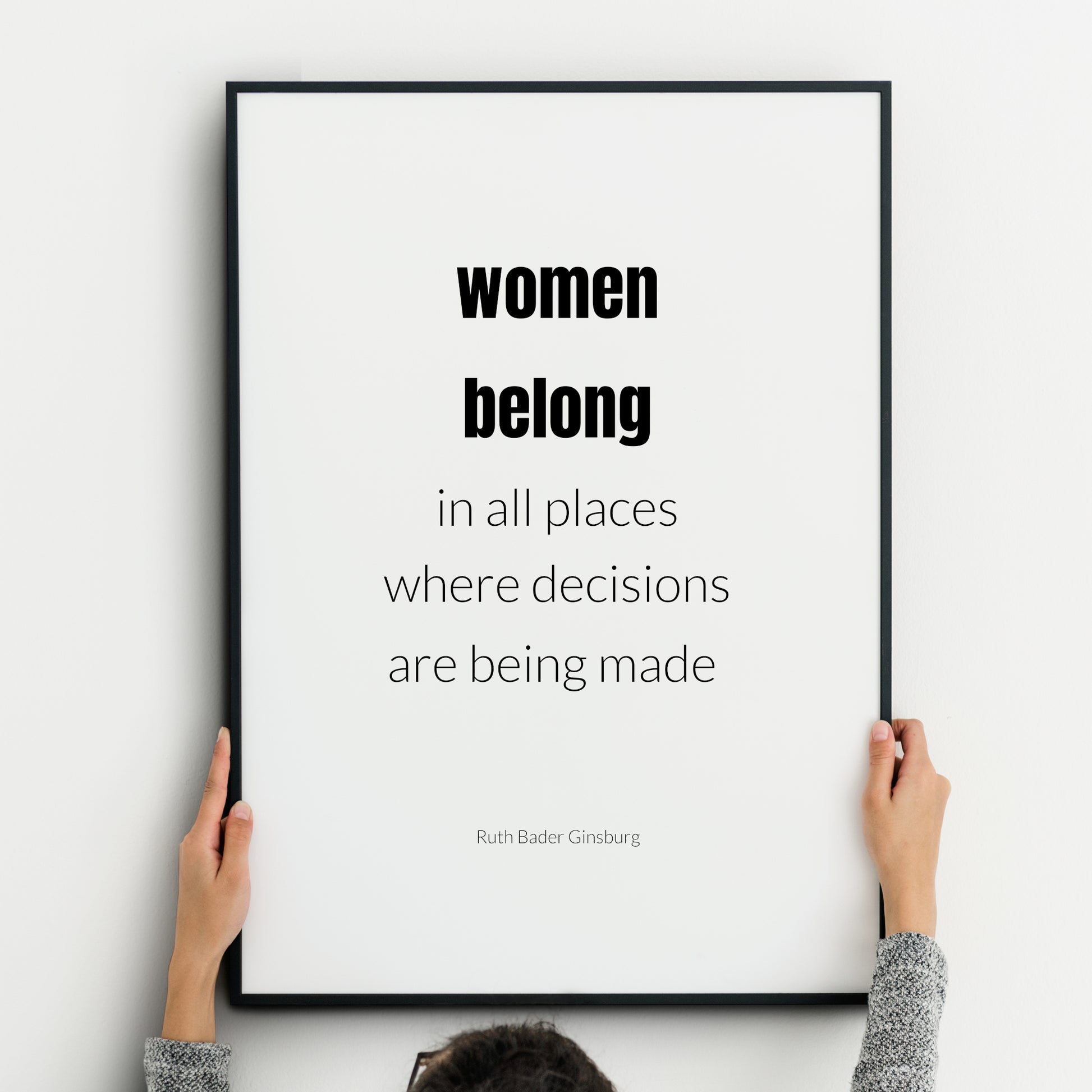 Single portrait typography print. Text reads: Women belong in all places where decisions are being made. An attribution to Ruth Bader Ginsburg is below. "Women belong" is in bold. Text is in a lower case sans serif font, black on white.