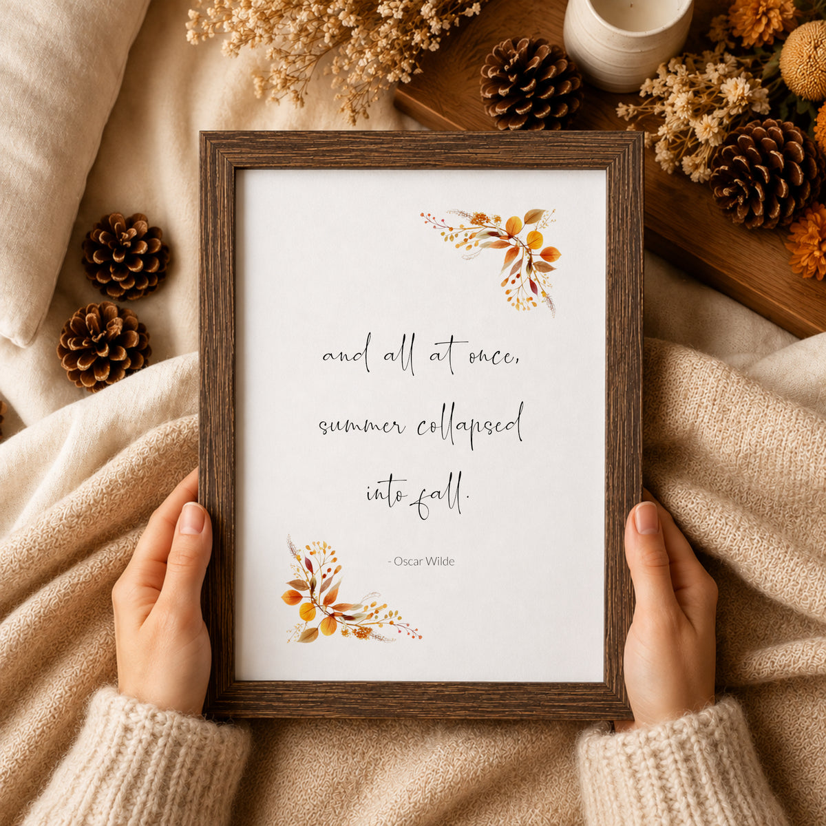 Single portrait print featuring the following quote by Oscar Wilde: and all at once, summer collapsed into fall. The quote is in a contemporary script font, with the attribution in a simple sans serif font. Autumnal foliage complements that quote.