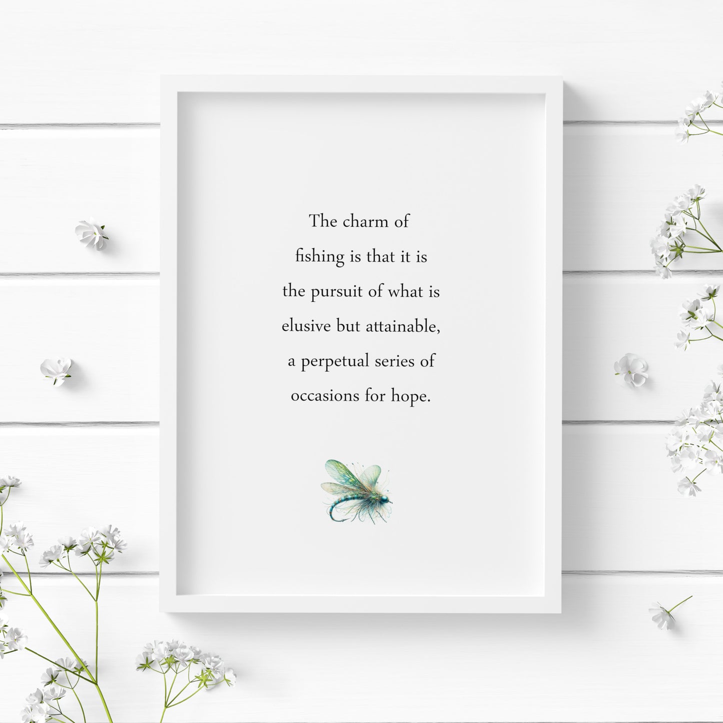 Single portrait typography print featuring a John Buchan quote about the charm of fishing. Text is black on a white background and in classic sentence case serif font. A delicate illustration of a fishing lure is positioned below in blues and greens.