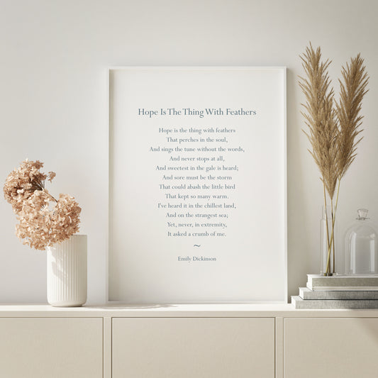 Single portrait typography print featuring the poem Hope Is The Thing With Feathers by Emily Dickinson. The text is in an elegant and traditional serif font. Text colour is a muted teal.