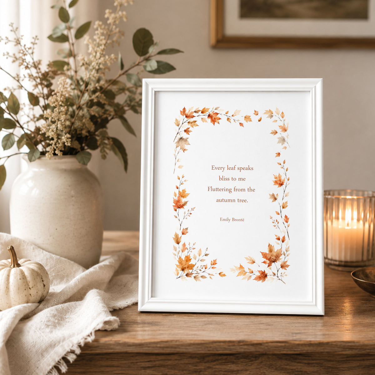 Single portrait print featuring the Emily Brontë’ quote “Every leaf speaks bliss to me, fluttering from the autumn tree.” The text is framed by watercolour-style autumn leaves. Text and illustration in warm autumn tones. Styling is contemporary and elegant. 