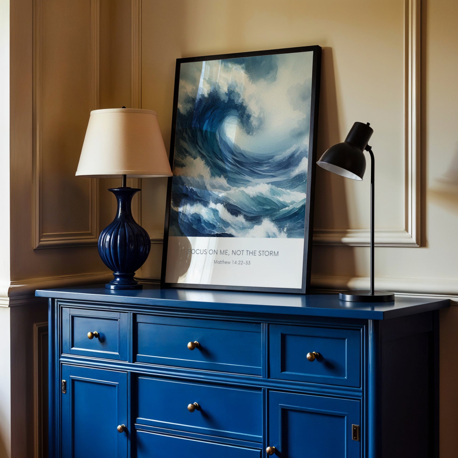 Single portrait illustrated print. Illustration is of a stormy sea showing a large crashing way in moody shades of blue and white. A bible verse is positioned below, reading: Focus on me, not the storm. An attribution to Matthew 14:22-33 is positioned below that again. All text is centre-aligned and in a sans serif font. Text is dark blue on a white background. Styling is contemporary and elegant.
