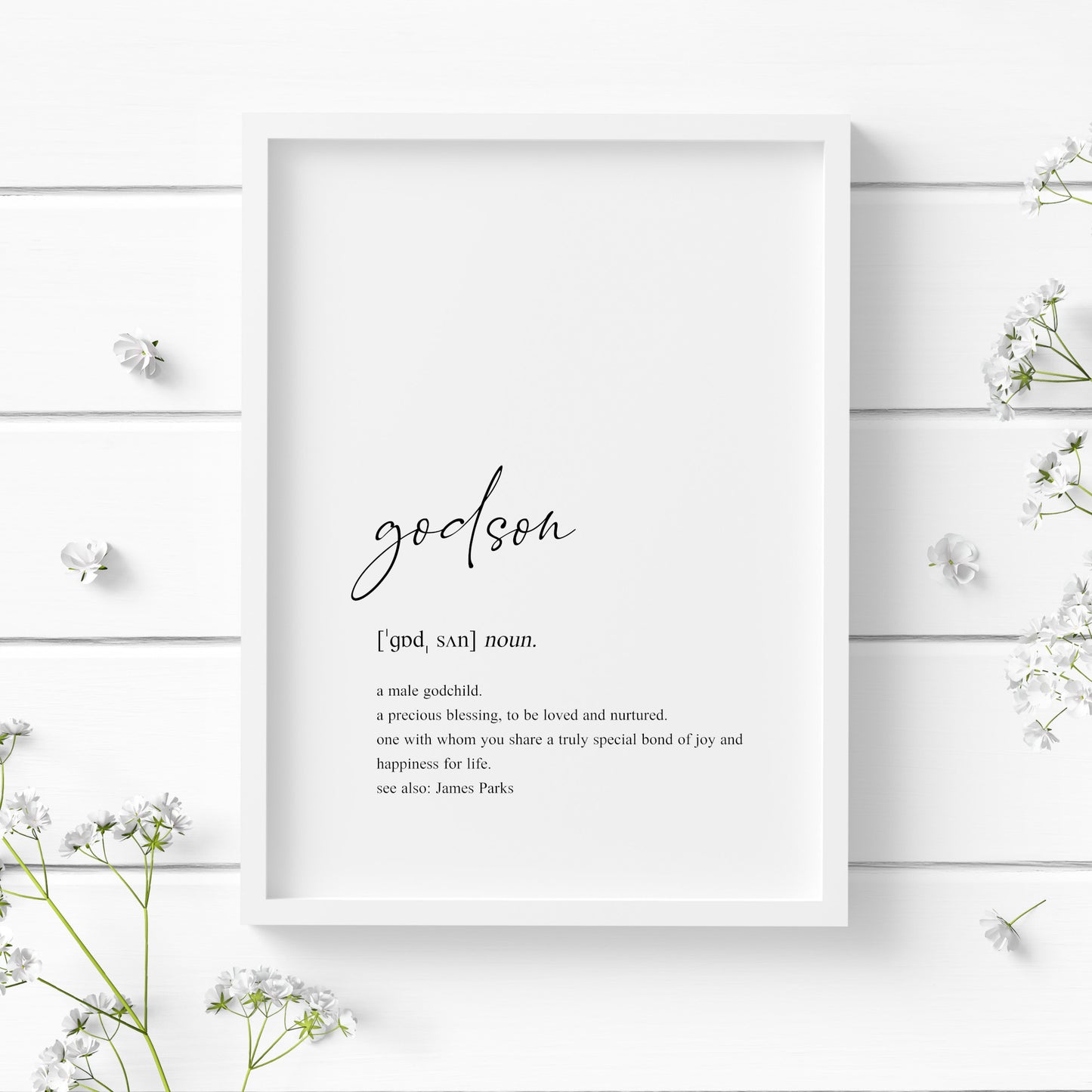 Single portrait typography print showing a dictionary style definition of the word godson. The word godson is in a modern script font, with the remaining text in a lower case serif font. The print is personalised with the name of the godson in a "see also:" section at the end of the definition. Text is black on a white background.