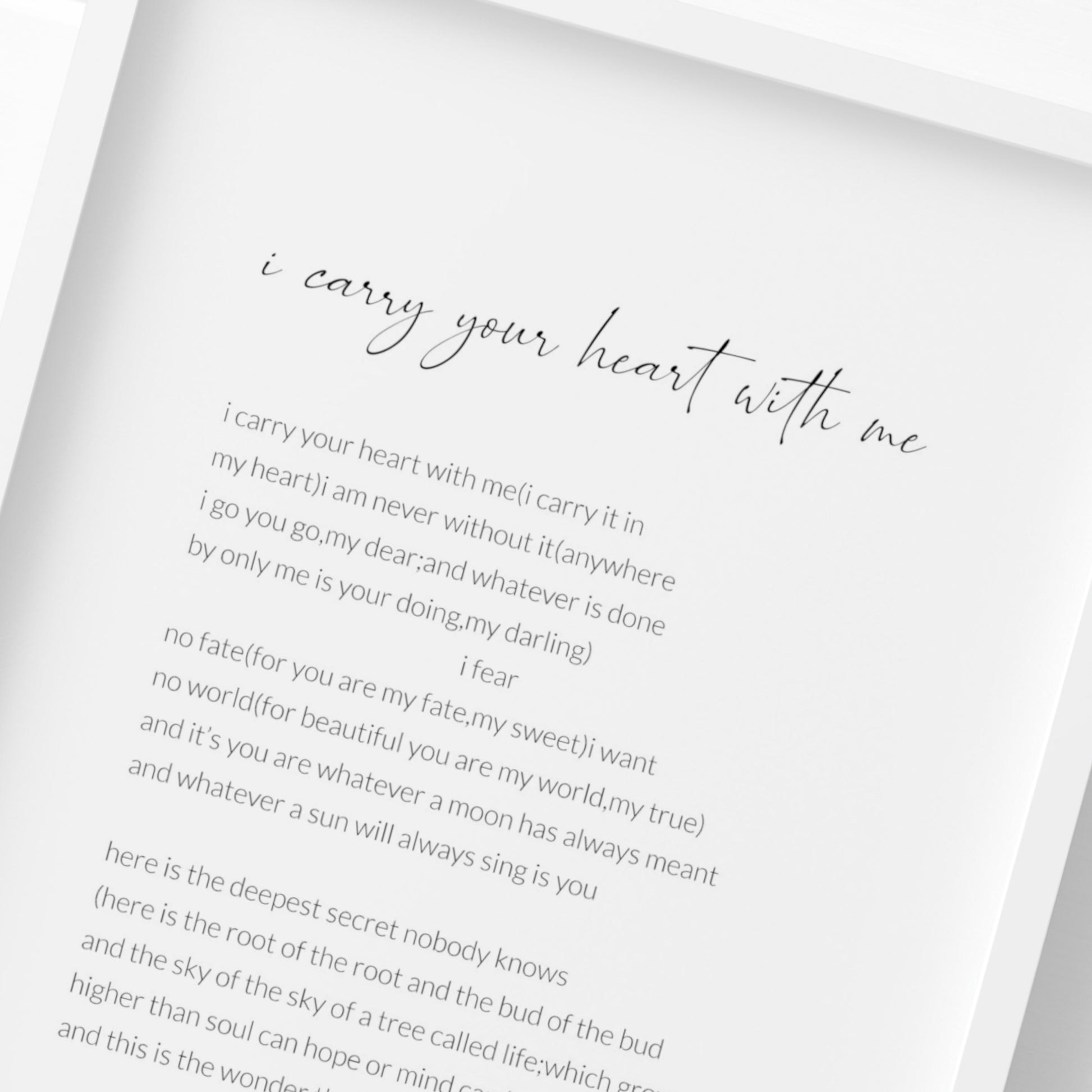 Single portrait typography print of the poem I Carry Your Heart With Me by E. E. Cummings. Title is in a modern script font. Attribution and body text are in a crisp sans serif font. All text is in lower case, and is black on a white background. Styling is modern and elegant.