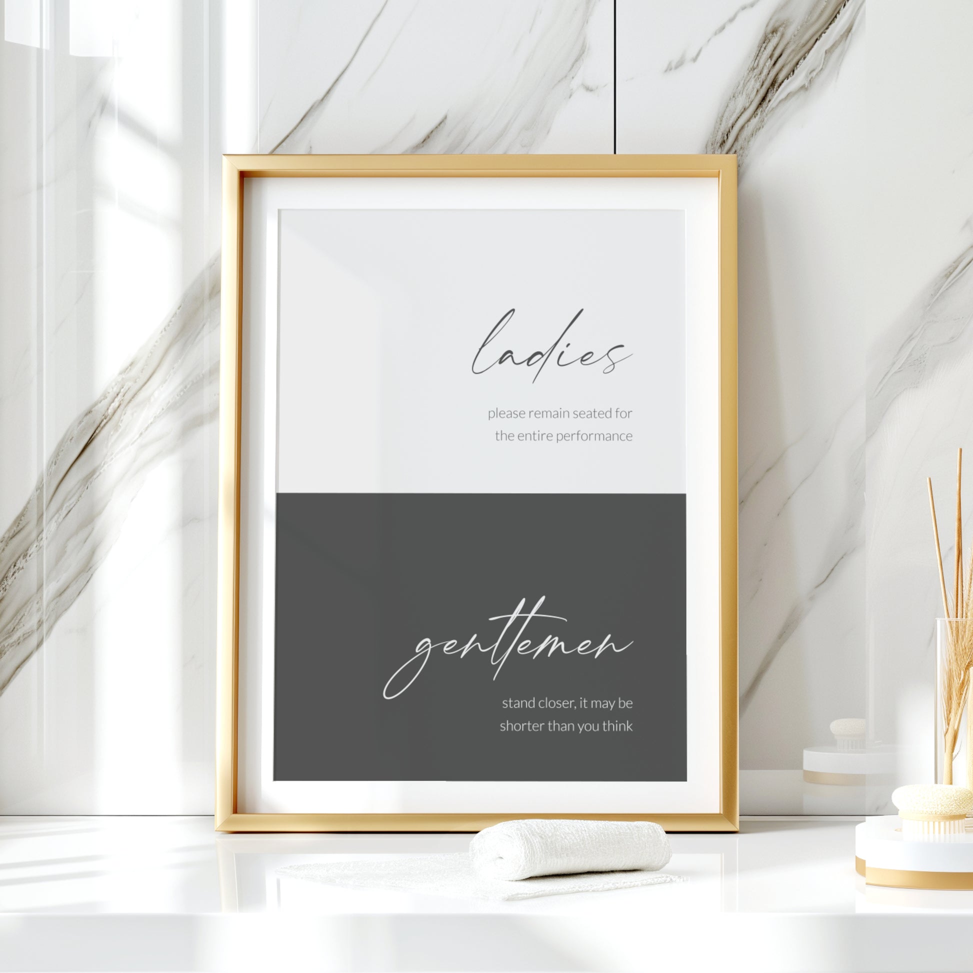 Single portrait typography print for the bathroom. It is colour-blocked in two shades of grey, pale with dark text at the top and dark with pale text at the bottom. The word ladies is positioned prominently in the upper block in a modern script font and gentlemen is in the same style in the lower block. Each then has below it a fun description of appropriate washroom etiquette, shown in a lower case lightweight sans serif font. All text is right-aligned. Styling is elegant and contemporary.