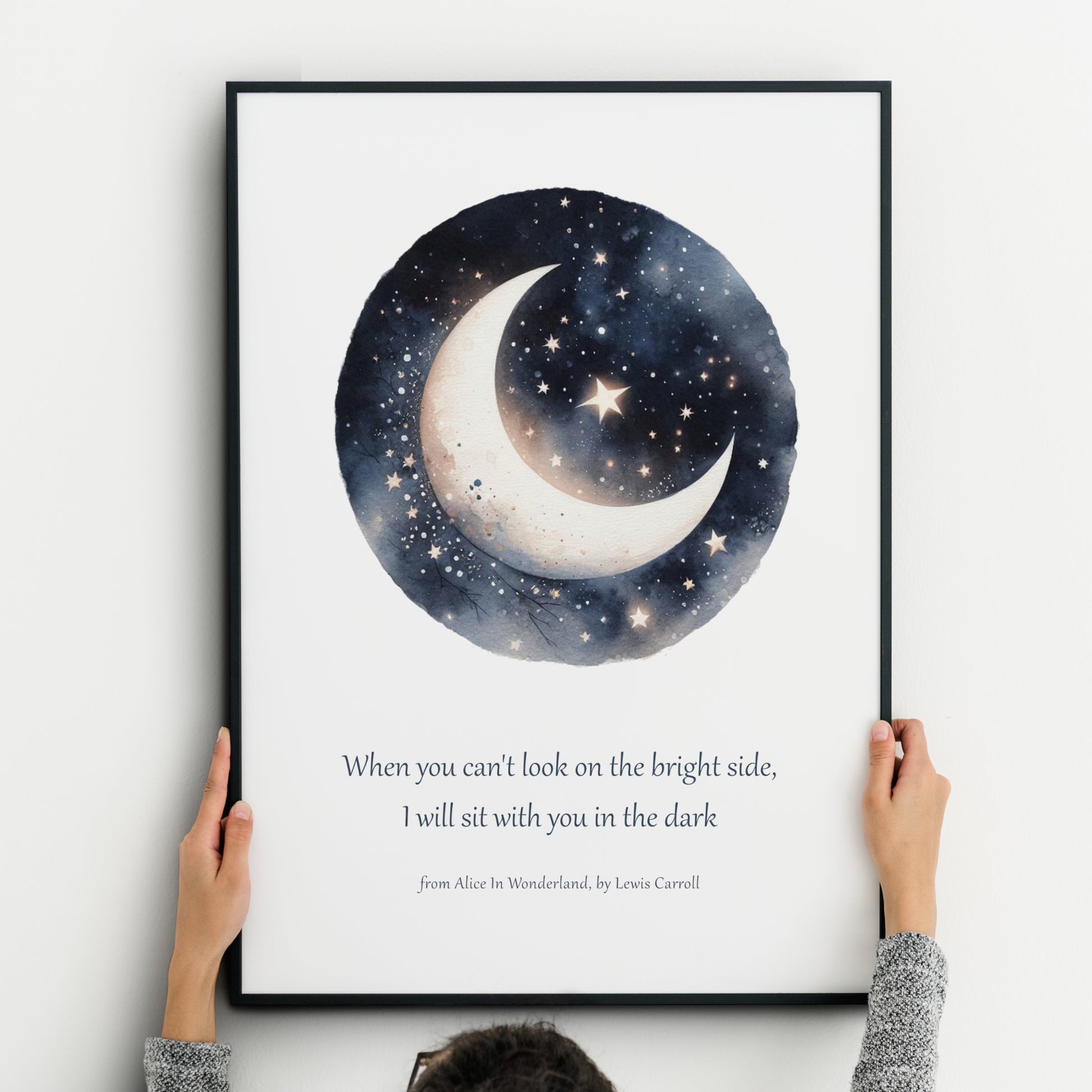 Unframed art print featuring a watercolor moon and stars illustration paired with the quote “When you can’t look on the bright side, I will sit with you in the dark” from Alice in Wonderland by Lewis Carroll.