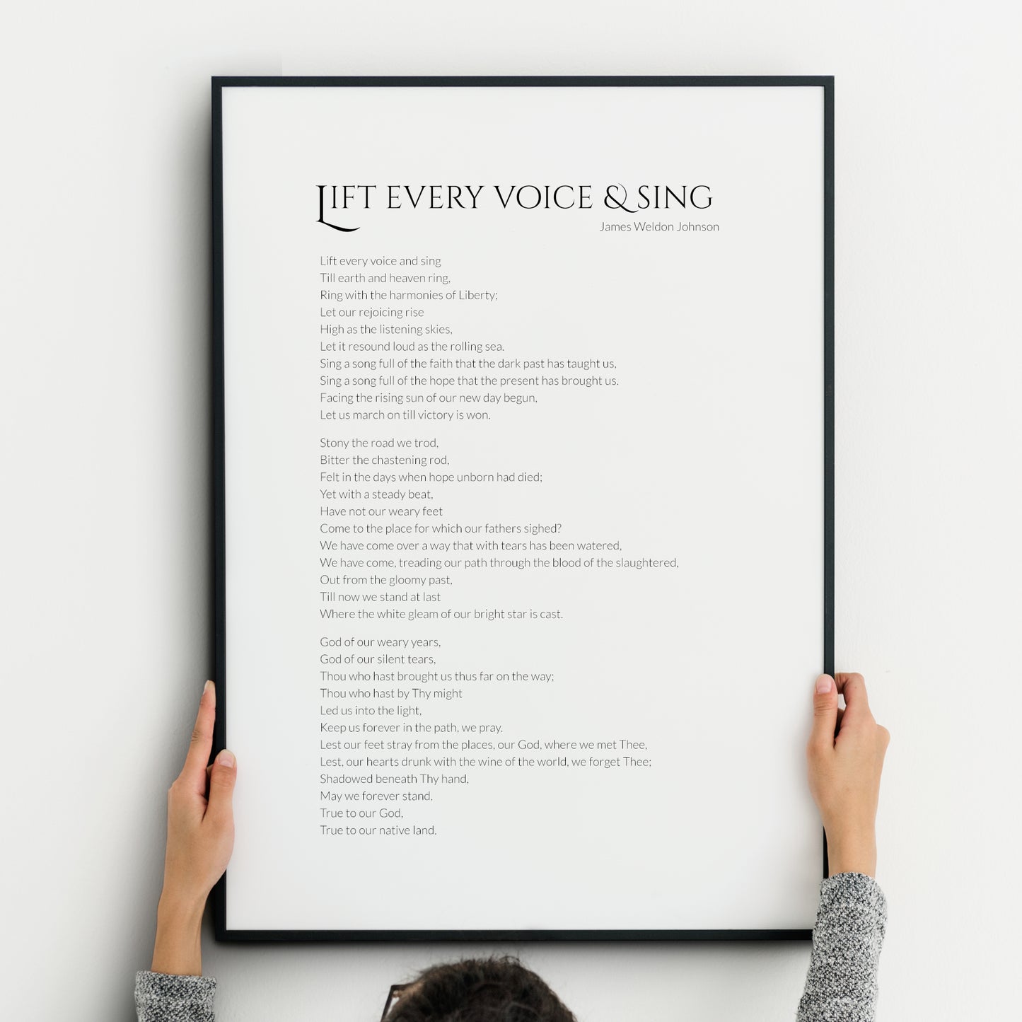 Single portrait typography print of the poem Life Every Voice And Sing by James Weldon Johnson. Title is in a formal upper case serif font, with body and attribution in a crisp sans serif font. Text is black on a white background.