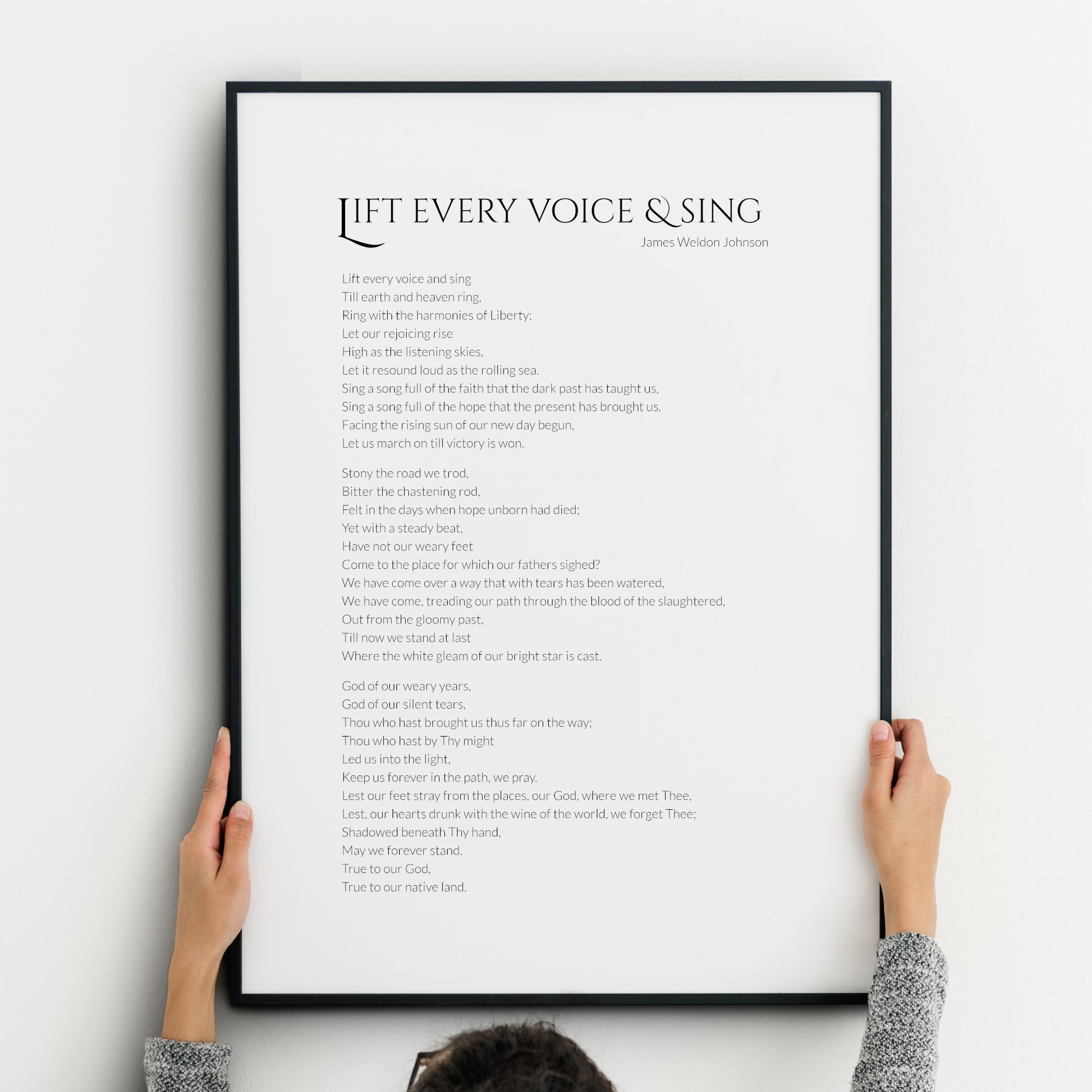 Single portrait typography print of the poem Life Every Voice And Sing by James Weldon Johnson. Title is in a formal upper case serif font, with body and attribution in a crisp sans serif font. Text is black on a white background.