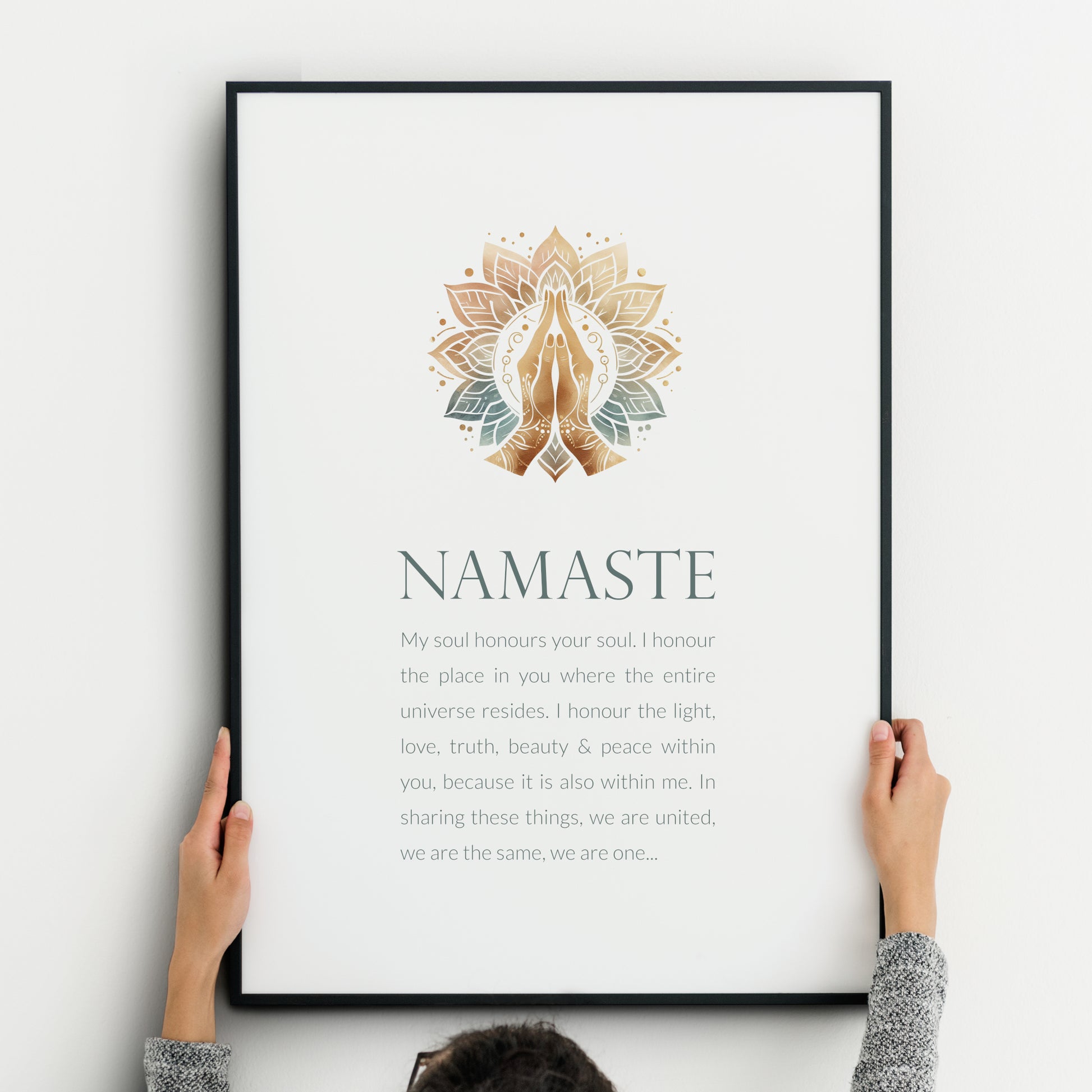Single portrait print with an illustration of prayer hands at the top and a short reflection on the word namaste below. Colour palette is natural tones and teal / blue-green. Background is white. Styling is modern and elegant.