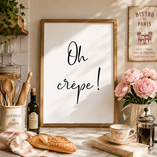 Single portrait typography print displayed in a kitchen setting. The text reads: Oh crêpe! The quote is displayed in a fun handwritten font that captures the essence of the quote.