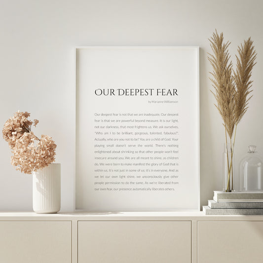Single portrait typography print featuring Our Deepest Fear by Marianne Williamson. Title is in a formal upper case serif font, with attribution and body text in a lightweight sans serif font. Body text is fully-justified and black on a white background. Styling is modern and elegant.
