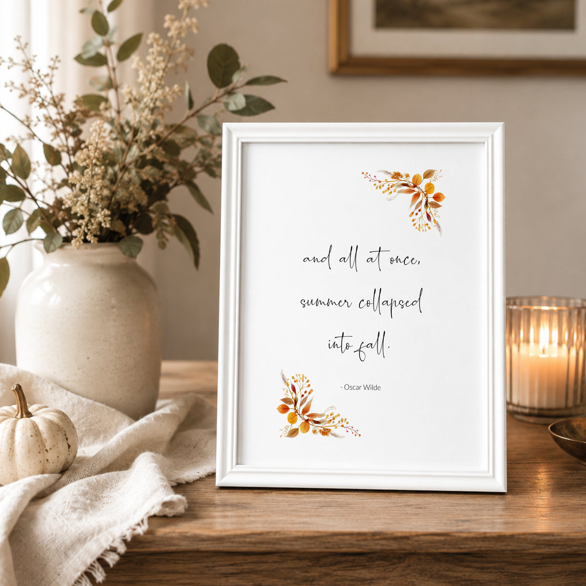 Single portrait print featuring the following quote by Oscar Wilde: and all at once, summer collapsed into fall. The quote is in a contemporary script font, with the attribution in a simple sans serif font. Autumnal foliage complements that quote.