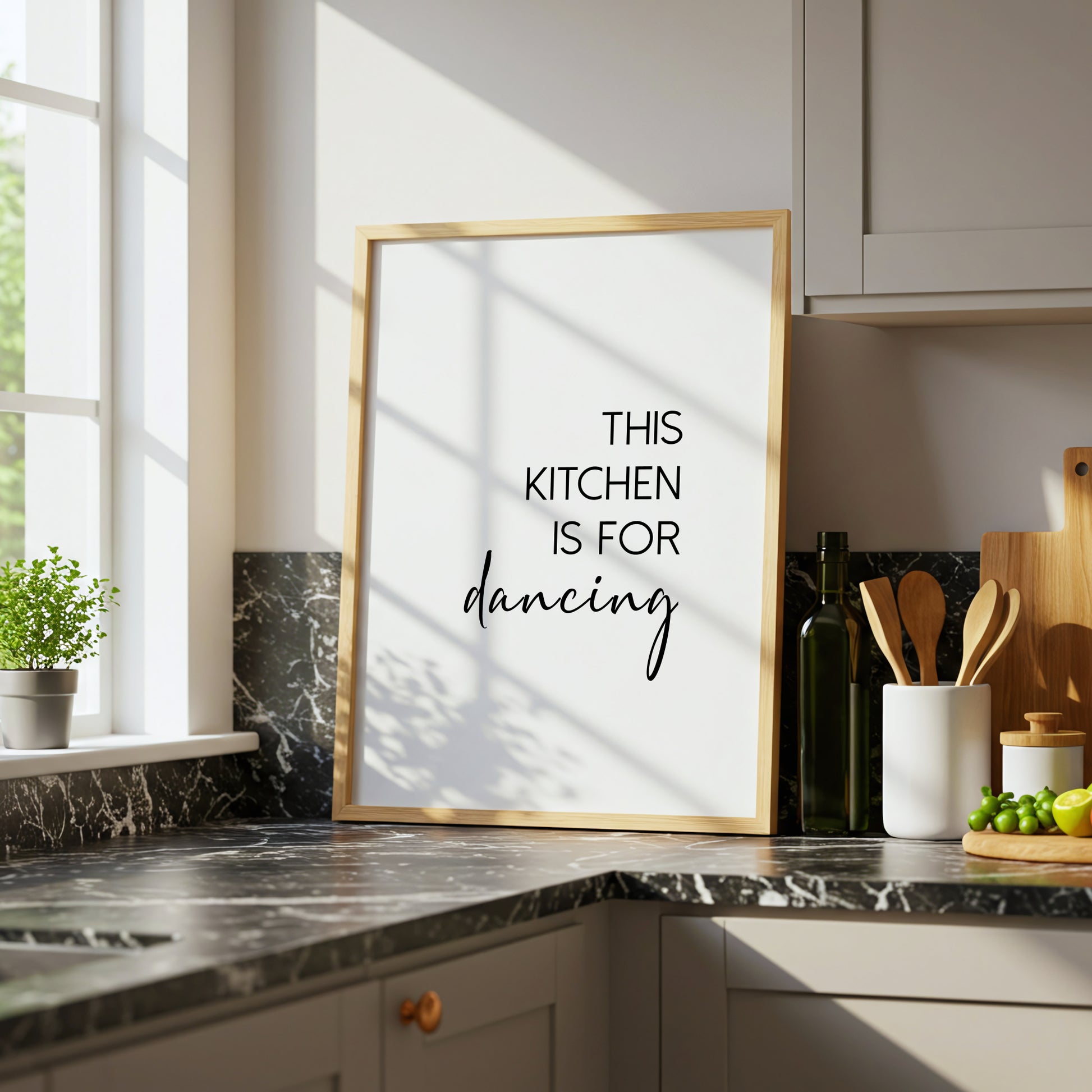 Single portrait typography print shown in a kitchen setting. Text reads: This kitchen is for dancing. The word dancing is displayed prominently in an elegant script font.