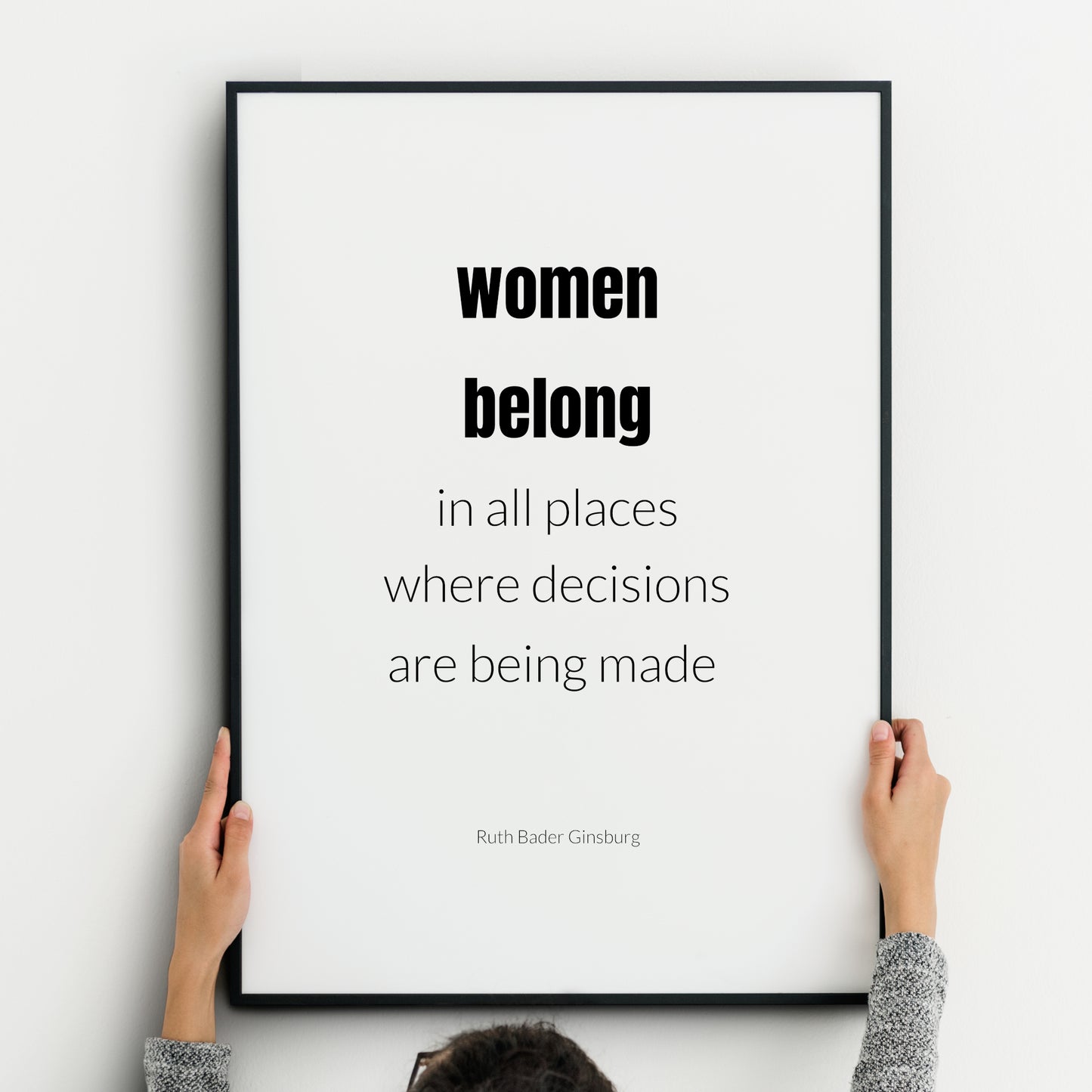 Single portrait typography print. Text reads: Women belong in all places where decisions are being made. An attribution to Ruth Bader Ginsburg is below. "Women belong" is in bold. Text is in a lower case sans serif font, black on white.