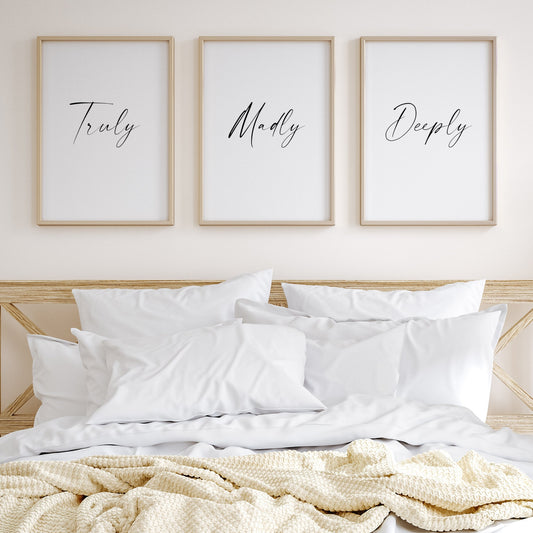 Set of 3 portrait typography prints positioned side by side. Text across the 3 reads: Truly Madly Deeply. All text is in a striking script font, black on a white background.