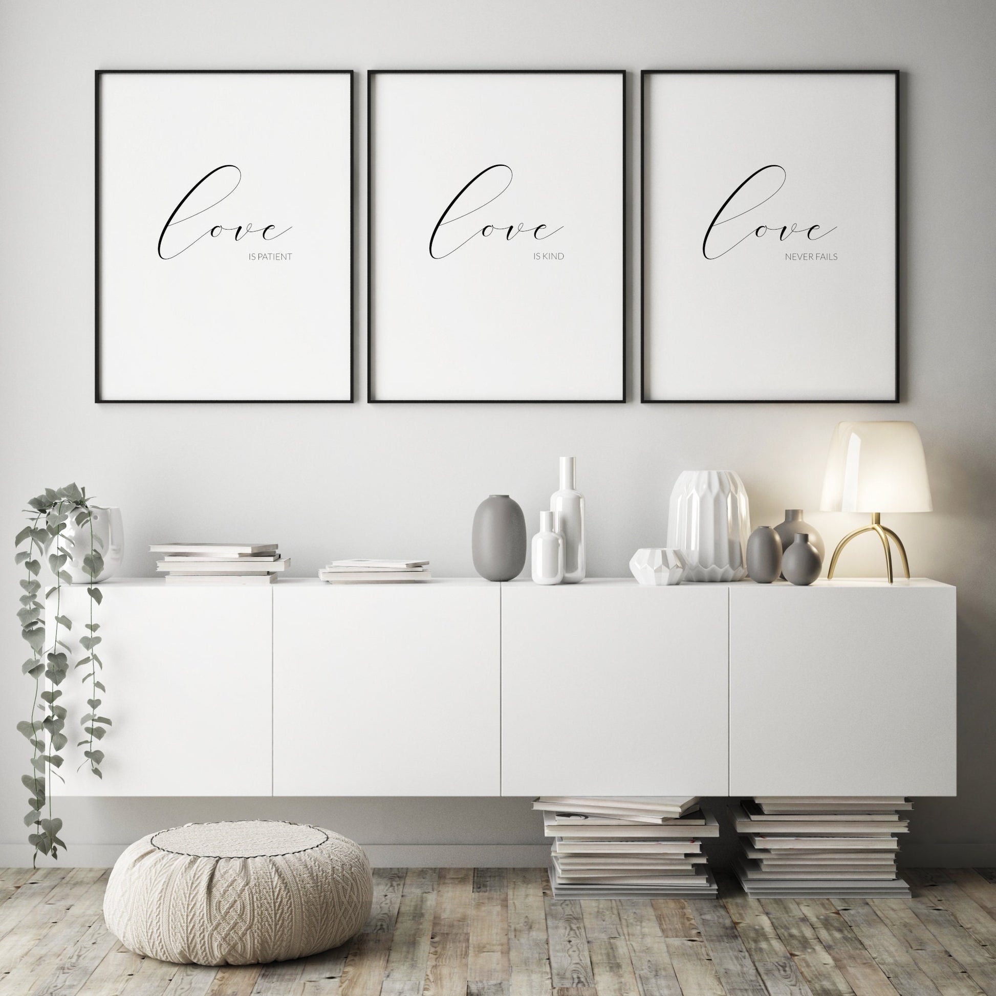 Set of 3 prints displayed in black portrait frames. The 1st reads love is patient, the 2nd love is kind and the 3rd love never fails. In each, the word love is in a large script font, with the other text in a sans serif font below and right-aligned.