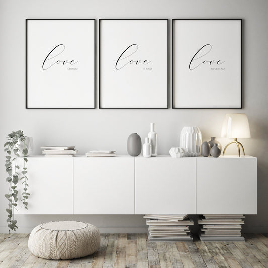 Set of 3 prints displayed in black portrait frames. The 1st reads love is patient, the 2nd love is kind and the 3rd love never fails. In each, the word love is in a large script font, with the other text in a sans serif font below and right-aligned.